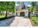 Attached two-car garage with brick-paved driveway and manicured landscaping at 3144 W Waverly Park, Tampa, FL 33629