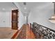 Hallway boasts dark hardwood floors, an antique-style runner, and an ornate wrought iron railing at 3144 W Waverly Park, Tampa, FL 33629