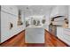 Well-lit kitchen with marble countertops, stainless steel appliances, and wooden flooring at 3144 W Waverly Park, Tampa, FL 33629