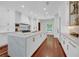 Bright kitchen with a marble island countertop, modern appliances, and hardwood flooring at 3144 W Waverly Park, Tampa, FL 33629
