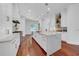Bright kitchen features a large island, white cabinetry, stainless steel appliances, and hardwood flooring at 3144 W Waverly Park, Tampa, FL 33629