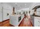 Bright kitchen boasts a marble island countertop, stainless steel appliances, and hardwood flooring at 3144 W Waverly Park, Tampa, FL 33629