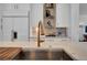 Close-up of a kitchen island featuring a gold faucet and quartz countertops at 3144 W Waverly Park, Tampa, FL 33629