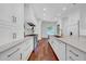 Modern kitchen with white cabinetry, marble countertops, stainless steel appliances, and hardwood floors at 3144 W Waverly Park, Tampa, FL 33629