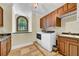 Laundry room with stone floors, cabinets, granite countertop, and modern washer and dryer at 3144 W Waverly Park, Tampa, FL 33629