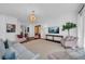 The living room features hardwood floors, plentiful windows, designer lighting and flows openly to other areas at 3144 W Waverly Park, Tampa, FL 33629