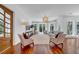 Bright living room with hardwood floors, plentiful windows with modern draperies, and seating for the whole Gathering at 3144 W Waverly Park, Tampa, FL 33629