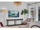 Light-filled living room featuring a turtle themed media display, designer lighting and picture windows at 3144 W Waverly Park, Tampa, FL 33629