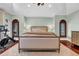 Large main bedroom with hardwood floors, area rug, and a stationary exercise bike at 3144 W Waverly Park, Tampa, FL 33629