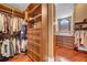 This walk-in closet boasts custom wood shelving and drawers for optimal storage and organization at 3144 W Waverly Park, Tampa, FL 33629