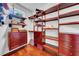Spacious walk-in closet with custom wood shelving, drawers, and cabinets offering ample storage space at 3144 W Waverly Park, Tampa, FL 33629