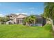 A lush backyard with a screened-in pool and patio area, perfect for outdoor living at 3228 Stonegate Falls Dr, Land O Lakes, FL 34638