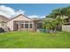The screened-in pool and patio area are surrounded by a green, well-maintained backyard at 3228 Stonegate Falls Dr, Land O Lakes, FL 34638