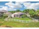 A beautiful home with a fenced yard, screened-in lanai, and lush landscaping creating a private outdoor oasis at 3228 Stonegate Falls Dr, Land O Lakes, FL 34638