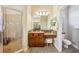Bathroom with a granite countertop sink, a walk-in shower with glass door and a separate toilet room at 3228 Stonegate Falls Dr, Land O Lakes, FL 34638