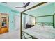 Bright bedroom with a four-poster bed, neutral carpet, walk-in closet and mint-green accent wall at 3228 Stonegate Falls Dr, Land O Lakes, FL 34638