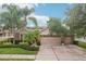 Charming home with a three-car garage, manicured lawn, and mature landscaping at 3228 Stonegate Falls Dr, Land O Lakes, FL 34638