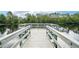 Fishing dock with wooden deck and bench seating at 3228 Stonegate Falls Dr, Land O Lakes, FL 34638