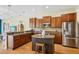 Spacious kitchen featuring stainless steel appliances, dark wood cabinets, and a granite island at 3228 Stonegate Falls Dr, Land O Lakes, FL 34638