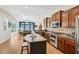 Modern kitchen with an island and stainless steel appliances overlooking the living area and backyard at 3228 Stonegate Falls Dr, Land O Lakes, FL 34638