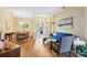 Bright and airy living room featuring hardwood floors, blue sofa, and open dining area with ample natural light at 3228 Stonegate Falls Dr, Land O Lakes, FL 34638