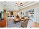 Open-concept living room flowing into the kitchen, with hardwood floors and a view of the pool at 3228 Stonegate Falls Dr, Land O Lakes, FL 34638
