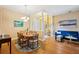 Bright living room and dining area featuring hardwood floors, elegant furniture and large windows at 3228 Stonegate Falls Dr, Land O Lakes, FL 34638