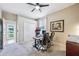 A well-lit home office with multiple monitors and chairs, featuring a window and a door to the exterior at 3228 Stonegate Falls Dr, Land O Lakes, FL 34638