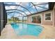 A beautiful screened-in pool and spa with a view of the lake, plus access to the living room at 3228 Stonegate Falls Dr, Land O Lakes, FL 34638