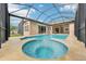 A crystal clear pool and spa with a water feature, all in a screened enclosure at 3228 Stonegate Falls Dr, Land O Lakes, FL 34638