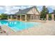 Community pool with brick-paved deck and plenty of lounge chairs for residents and guests at 3228 Stonegate Falls Dr, Land O Lakes, FL 34638