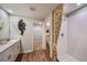 Bathroom with double sink vanity, decorative mirror, and shower stall with patterned shower curtain at 36953 Sagemoor Dr, Zephyrhills, FL 33541