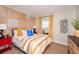 Cozy bedroom is brightly lit with colorful pillows and decorative accents at 36953 Sagemoor Dr, Zephyrhills, FL 33541