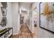 Long hallway featuring wood floors and decorative pictures on the walls at 36953 Sagemoor Dr, Zephyrhills, FL 33541