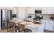 Bright kitchen featuring an island, white cabinets, stainless steel appliances, and seating for four at 36953 Sagemoor Dr, Zephyrhills, FL 33541