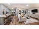 Inviting open-concept living space with wood floors connecting the kitchen and dining areas at 36953 Sagemoor Dr, Zephyrhills, FL 33541