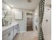 Clean bathroom includes double sinks, sleek vanity, and a shower with patterned curtains at 36995 Sagemoor Dr, Zephyrhills, FL 33541