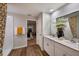 Spacious bathroom boasts double sinks, modern fixtures, and a view into the bedroom at 36995 Sagemoor Dr, Zephyrhills, FL 33541