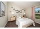 Charming bedroom with a comfortable bed, stylish nightstands, and whimsical decor at 36995 Sagemoor Dr, Zephyrhills, FL 33541