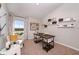Home office area featuring a wooden desk, a comfortable chair, and natural light at 36995 Sagemoor Dr, Zephyrhills, FL 33541