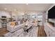 Bright living room featuring comfortable sofas, stylish decor, lots of natural light, and an open-concept layout at 36995 Sagemoor Dr, Zephyrhills, FL 33541