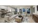 Inviting living room connected to a kitchen area, featuring comfortable sofas, natural light, and contemporary decor at 36995 Sagemoor Dr, Zephyrhills, FL 33541