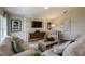 Comfortable living room with stylish decor, a large TV, and a cozy seating arrangement at 36995 Sagemoor Dr, Zephyrhills, FL 33541