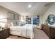 Bright main bedroom with a large bed, soft lighting, and neutral tones creating a relaxing and comfortable space at 36995 Sagemoor Dr, Zephyrhills, FL 33541