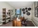 Charming home office with wood desk, bookshelf, decor, neutral colors, and a relaxing sitting area near the window at 36995 Sagemoor Dr, Zephyrhills, FL 33541