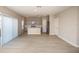 Open-concept living space with modern flooring seamlessly connecting to the kitchen at 37009 Sagemoor Dr, Zephyrhills, FL 33541
