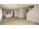 Open-concept living space with sleek flooring, staircase, and access to the kitchen at 37009 Sagemoor Dr, Zephyrhills, FL 33541