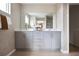 Bathroom featuring double vanity, decorative mirror, and modern fixtures at 37029 Sagemoor Dr, Zephyrhills, FL 33541