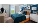 Beautiful bedroom with bright blue accents, modern furniture, and a lovely window view, offering a tranquil retreat at 37029 Sagemoor Dr, Zephyrhills, FL 33541