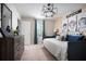 This cozy bedroom features a daybed, a dresser, and a Skater-themed monkey artwork at 37029 Sagemoor Dr, Zephyrhills, FL 33541